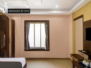 a bedroom with a bed and a window at Super Collection O New Town DD Block in Kolkata