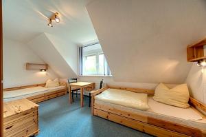 a room with two beds and a table at Luv in Zingst