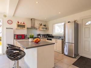 a kitchen with a stainless steel refrigerator and a counter at Holiday Home La maison de Toul an Dour by Interhome in Plouarzel