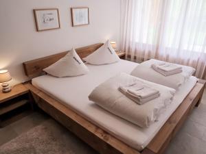 a bedroom with two beds with white pillows on them at Apartment Utoring Acletta-2 by Interhome in Disentis