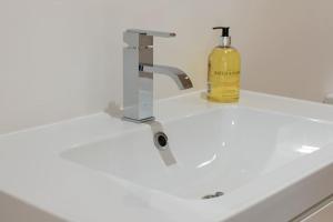 a white sink with a bottle of wine on it at Long Range 2, Henham Park Nr Southwold in Beccles