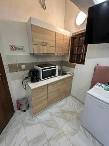 a small kitchen with a microwave on a counter at Ano Poli Studios 4 in Thessaloniki