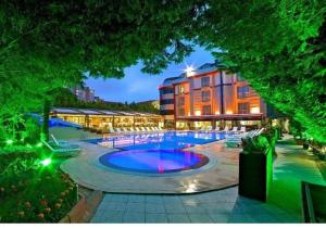 a hotel with a large pool in front of a building at Gardan Hotel in Beylikduzu