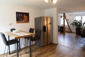 a kitchen and dining room with a table and a refrigerator at Ferienwohnung Moselallee 5 Sterne in Moselkern