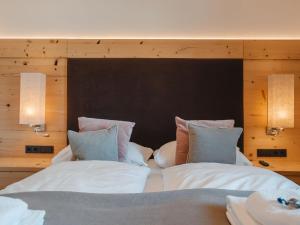 a bedroom with a large bed with two pillows at Apartment Lakeside Luxury Apartments by Interhome in Zell am See