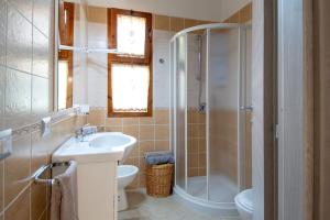 a bathroom with a shower and a sink and a toilet at Casa Kody a 500 mt dalla spiaggia di Geremeas in Geremeas +25 photos
