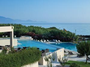 a swimming pool with a view of the ocean at Atlantica Eleon Grand Resort in Tragaki