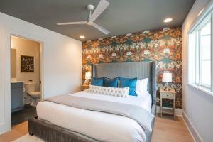 a bedroom with a large bed with blue pillows at Fabulous Location Walk to Food & Bars Roof Deck in Nashville