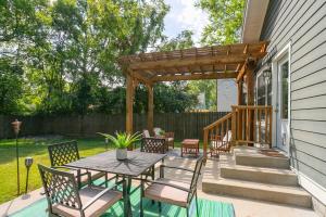 a patio with a table and chairs and a wooden pergola at Location Walk to Coffee Shops mins to Downtown in Nashville