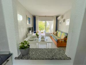 a living room with a couch and a table at Apartamentos Tierra de Irta 3000 in Peniscola