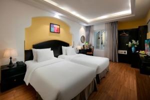 Giường trong phòng chung tại Hanoi Harmonia Hotel & Spa