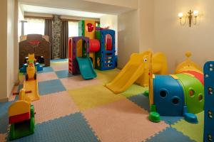 a childrens play room with a slide and playground equipment at Lake Manyara Kilimamoja Lodge in Mto wa Mbu