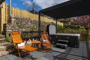 two chairs and a hot tub on a patio at Grange Manor in Grange Over Sands