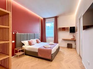 a small bedroom with a bed and a window at Reno Suite Bologna in Bologna