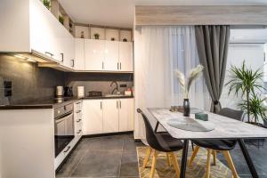 a kitchen with a table and chairs in a room at Apartment anghome A3 in Metaksourgio in Athens