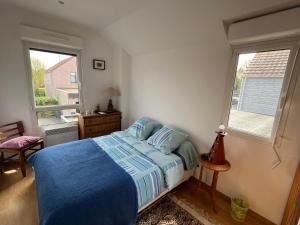 a bedroom with a blue bed and two windows at Sainghin's Break in Sainghin-en-Mélantois +2 photos