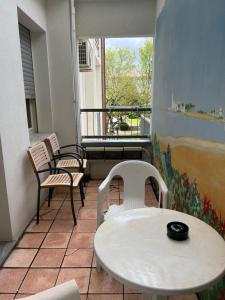 切爾維亞的住宿－布里斯托酒店，阳台配有两把椅子、一张桌子和一张桌子