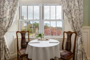a table and two chairs in front of a window at Grange Manor in Grange Over Sands