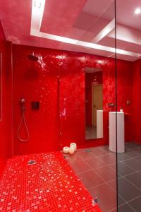 a red bathroom with a shower with a red wall at Messinian Project in Khóra