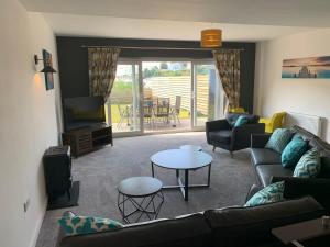 a living room with a couch and a table at The Mariners' Beacon Torquay in Torquay