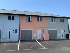 a building with four garage doors and a parking lot at The Mariners' Beacon Torquay in Torquay