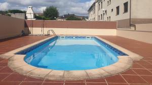 a swimming pool on the roof of a building at Apartamento Ancora Caldebarcos in San Mamede de Carnota