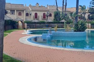 a swimming pool in front of a house at Costa Ballena Casa, pie playa y golf in Costa Ballena