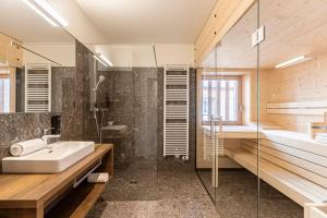 a bathroom with a sink and a shower at Almresort Sonnenalpe by ALPS RESORTS in Sonnenalpe Nassfeld