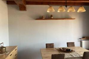 a dining room with a table and chairs and lights at Casita Planes Surroca in Bourg-Madame +2 photos