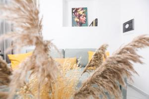 a couch with yellow pillows in a living room at Arieni Places in Corfu