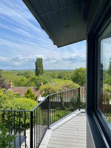 a balcony with a view of the countryside from a house at Stunning Hillside House in Langport