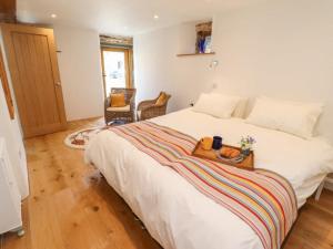 a bedroom with a bed with a tray on it at The Meeting House in Sheepstor