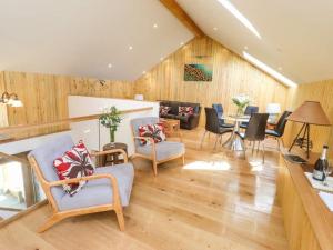 a large living room with chairs and a table at The Meeting House in Sheepstor