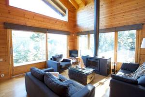 a large living room with couches and a fireplace at Cabana Coll Sisé in La Molina
