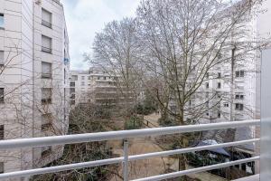 a view from a balcony of buildings and trees at Star Of Life in Courbevoie