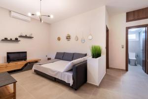 a bedroom with a bed and a desk and a tv at Casa Del Sol in Sikia