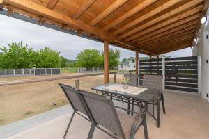 a patio with a table and chairs and a basketball court at Casa Del Sol in Sikia