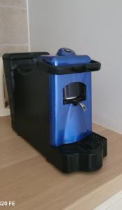 a blue coffee maker on a stand on a table at Casa Porta Vecchia in Monopoli