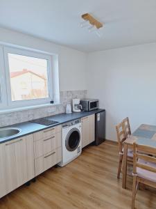 a kitchen with a sink and a washing machine at Erra Guest Apartement in Erra