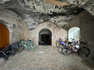 a group of bikes parked in a stone tunnel at 1Dest - Segantini Loft in Arco