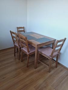a wooden table with two chairs and a table and a table and chairsktop at Erra Guest Apartement in Erra