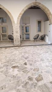 a patio with chairs and an archway in a building at Limassol Old Town Mansion in Limassol