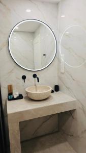 a bathroom with a sink and a mirror at Limassol Old Town Mansion in Limassol