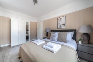 a bedroom with a large bed with two pillows on it at The Crystal Palace Collection in London