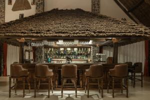 a bar with a group of chairs around it at Lake Manyara Kilimamoja Lodge in Mto wa Mbu