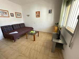 a living room with a couch and a table at Bungalows Peñismar II 3000 in Peniscola