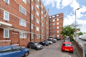 a row of cars parked in front of a brick building at The Crystal Palace Collection in London