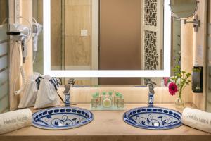 a bathroom with two blue and white sinks and a mirror at Hotel Saray in Granada