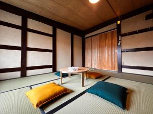 um quarto com uma mesa e um sofá em Biwako Makino Hifumikan em Takashima