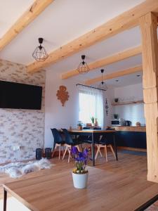 a kitchen and dining room with a table and chairs at Domek Z Widokiem Szaflary in Szaflary